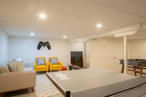 a living room with a ping pong table and chairs at Private Pool Central AC Dog Friendly in Barnstable