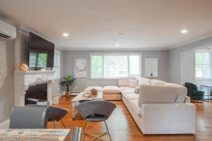 a living room with a white couch and a fireplace at Private Pool Central AC Dog Friendly in Barnstable