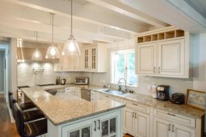 a kitchen with white cabinets and granite counter tops at Private Pool Central AC Dog Friendly in Barnstable +27 photos