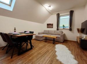 a living room with a table and a couch at Ferienwohnung Glashütte in Sankt Michael im Lungau