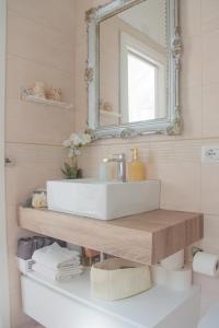 a bathroom with a white sink and a mirror at MARVELOUS CAPRI - Sea View Villa in Capri
