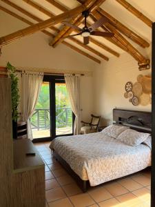a bedroom with a bed and a large window at Casa Panaca Portal 12 in Quimbaya +53 photos