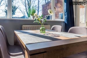 a table with a vase of flowers on top of it at Newly Refurbished Flat Parking 2 Bedrooms 4 Guests in Kenton +27 photos