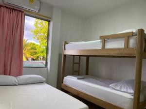 two bunk beds in a room with a window at Habitaciones Melany in Coveñas