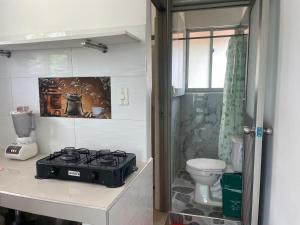 a kitchen with a stove and a toilet at Habitaciones Melany in Coveñas +84 photos