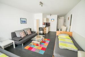 a living room with a couch and a table at Murthum Apartments in Leinfelden-Echterdingen