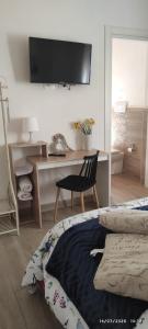 a bedroom with a desk and a bed and a chair at HOME DOLCE LUNA in Castelvetrano Selinunte