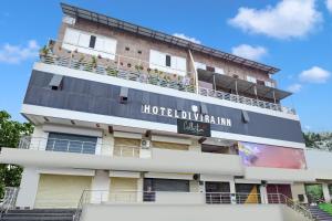 a hotel building with a sign on it at HOTEL O DIVIRA INN in Dhanbād