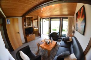 a living room with a couch and a table at Ferienhäuser Meiß - Feriendorf Öfingen Schwarzwald in Öfingen
