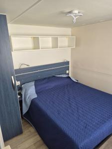 a bedroom with a blue bed in a room at Al Fresco Mare in Triscina