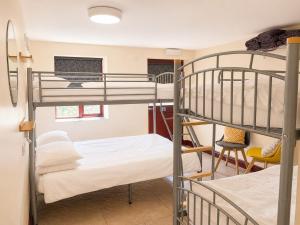 a room with two bunk beds and a table at Howgills Barn in Sedbergh +69 photos