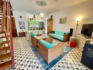 a living room with a couch and a tv at Terraced house with garden and pool in Porto Santa Margherita di Caorle