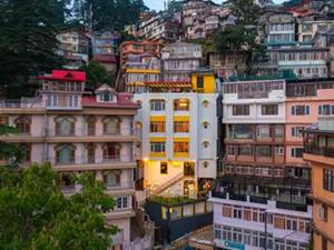 a group of buildings on top of a mountain at The Hosteller Shimla in Shimla