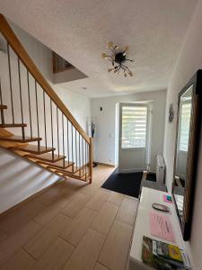 a living room with a staircase with a spider on the ceiling at Ferienwohnung Litau in Sonthofen