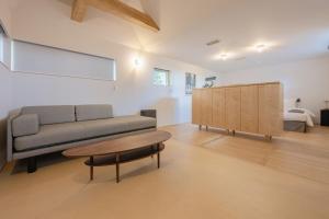 a living room with a couch and a table at 椿森コムナStay in Chiba