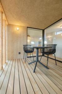 a dining room with a table and two chairs at 椿森コムナStay in Chiba