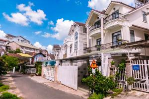 a row of white houses on a street at Hoanglee Villa in Da Thanh