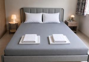 a bed with two white towels on top of it at J-Club De Knapzak / La Besace in Bohan