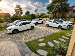 a row of parked cars parked in a driveway at The Windy Villa Ba Vì in Xóm Gốc Gia