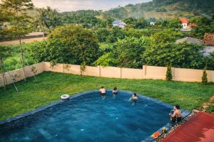 a group of people in a swimming pool at The Windy Villa Ba Vì in Xóm Gốc Gia +11 photos