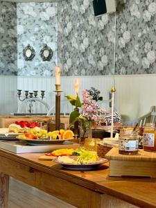 a table with fruits and vegetables on top of it at Kaptenshuset B&B och Hotell in Kivik