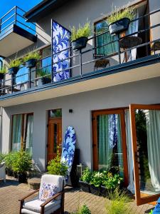 a building with lots of plants on the balconies at SURF HOUSE DREAMERS COAST in Klaipėda