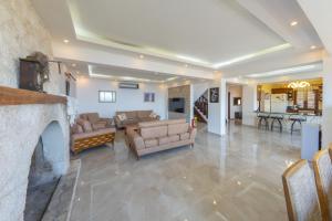 a living room with couches and a fireplace at Villa Elfuze in Kalkan