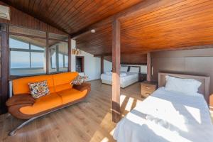 a bedroom with an orange couch and a bed at Villa Elfuze in Kalkan +61 photos