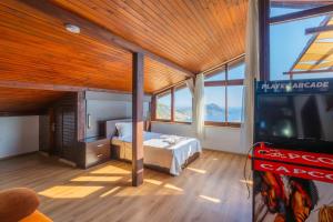 a bedroom with a bed and a flat screen tv at Villa Elfuze in Kalkan
