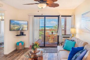 a living room with a couch and a glass table at Central and Bright 2 BR, 2 BA, Pool and Oceanview in Lihue