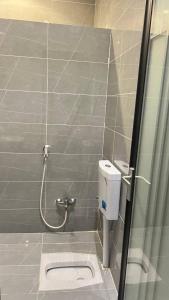 a bathroom with a shower stall with a toilet at شقه فندقه in Hail