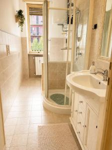 a bathroom with a shower and a sink at Quick Home Victoria in Biella