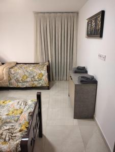 a room with two beds and a table in it at Dani's Sea Breeze in Oran