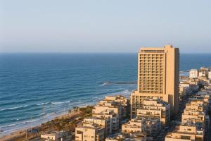an aerial view of a building and the ocean at AREAN Hotel Bat Yam in Bat Yam
