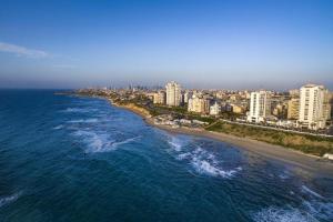 an aerial view of a beach with buildings and the ocean at AREAN Hotel Bat Yam in Bat Yam