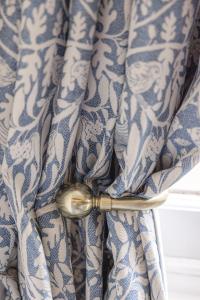 a spoon sticking out of a blue and white curtain at The Green Man in Dunchurch