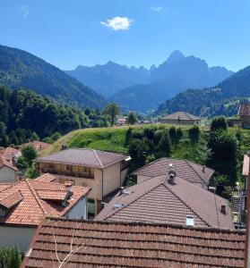 a view of a village with mountains in the background at Villa Mezzo in Paularo