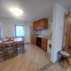 a kitchen with a table and a table and a dining room at Villa Mezzo in Paularo