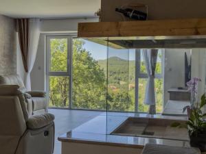 a living room with a large glass window with a view at Villa Petar Stone in Kamensko
