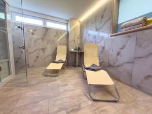 two chairs in a bathroom with a shower at Villa Petar Stone in Kamensko +16 photos