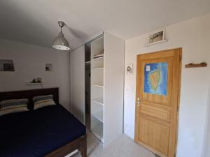 a bedroom with a bed and a wooden door at Merozzini in Moltifao