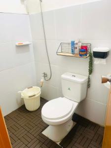 a bathroom with a white toilet and a sink at Sta Cruz Laguna Transient House in Santa Cruz +14 photos
