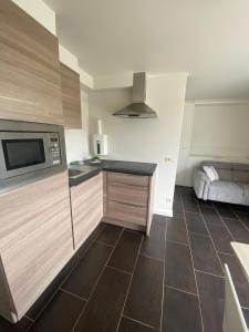 a kitchen with a sink and a microwave at Studio Cosy 2 in Han-sur-Lesse