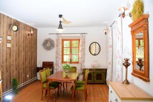 a dining room with a table and chairs in a room at Erdei Kisház Sümeg in Sümeg