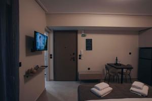 a room with a room with a table and a television at Luna house in Chalkida