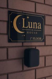 a sign on a brick wall with a luna house at Luna house in Chalkida +15 photos