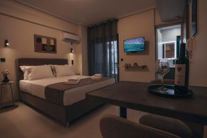 a bedroom with a bed and a table with a wine glass at Luna house in Chalkida