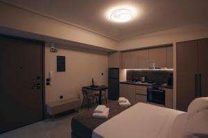 a bedroom with a bed and a kitchen with a table at Luna house in Chalkida
