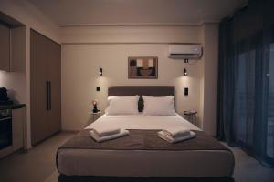 a bedroom with a bed with two towels on it at Luna house in Chalkida