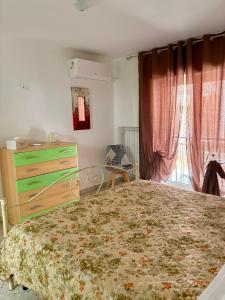 a bedroom with a bed and a dresser and window at I Due Timidi in Putignano